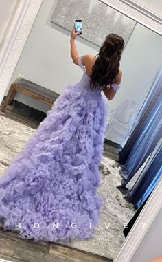 a woman in a purple dress taking a selfie