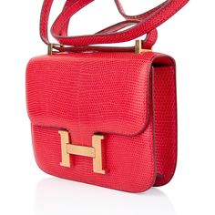 Guaranteed authentic exquisite limited edition very rare Hermes Micro Constance features rich Rouge Lizard.Lush with Gold hardware.Perfect for year round wear.This is a highly collectible Hermes bag.Carried by hand, over the shoulder, or cross body. HERMES PARIS MADE IN FRANCE is stamped on front under flap.Light wear to hardware. One tiny mark on rear.final saleBAG MEASURES:LENGTH 5.5"TALL 4"WIDTH 1.5" CONDITION:EXCELLENT TIDS ‘n BITS: The Hermès Constance was originally created in 1959 by in h Luxury Satchel Shoulder Bag, Luxury Gold Bag With Palladium Hardware, Luxury Gold Shoulder Bag With Palladium Hardware, Luxury Formal Bags With Palladium Hardware, Classic Gift Bags With Gold-tone Hardware, Luxury Shoulder Bag With Detachable Strap, Luxury Shoulder Bag With Branded Hardware As Gift, Luxury Shoulder Bag With Dust Bag For Gift, Luxury Shoulder Bag With Detachable Handle As Gift