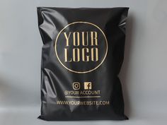 a black bag with gold foil on the front that says your logo and is placed against a white background