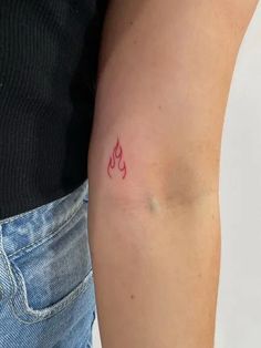 a person with a small tattoo on their arm