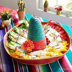 a colorful tray with some candy sticks and a small christmas tree on top of it