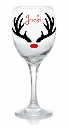 a wine glass with reindeer antlers painted on it's face and the word jacki written in red