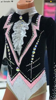 a female figure is wearing a black and white leotard with pink trims