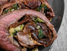 some meat is laying on a plate with broccoli