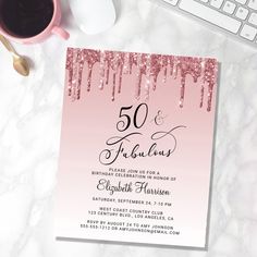 a pink and black 50th birthday party card on a table with a cup of coffee