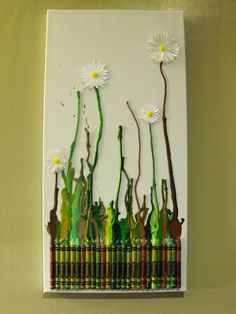 an art project made out of crayons and colored pencils with daisies on them