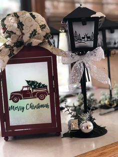 an old fashioned christmas card holder with a ribbon tied around it and a holiday decoration on top