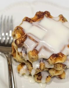 a white plate topped with dessert covered in icing