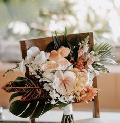 a bouquet of flowers sitting on top of a wooden chair