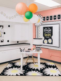 an office decorated in black, white and pink with flowers on the rugs that are hanging from the ceiling