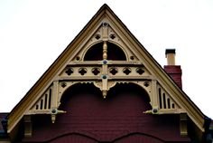 the top of a building with a clock on it's face and an arched window