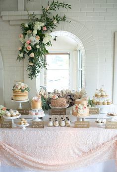 a table topped with lots of cakes and desserts