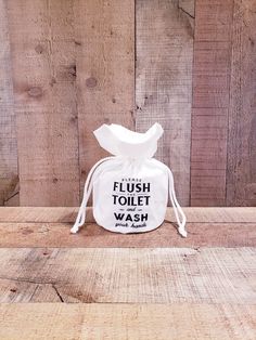 a white toilet bag sitting on top of a wooden table