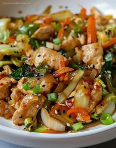 a white bowl filled with chicken and vegetables