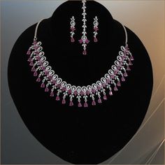 American diamond CZ Green,white and ruby stone studded rhodium plated bridal jewelry. Indian Bollywood style AD necklace, earrings and Tikka makes makes the perfect gifts for bridesmaids,Wife, Mother, Sister or Gift for Loved ones. Total length of the necklace + length of the extender is 17 inches. Length of Earring is 1.5 inches. Best suitable for Party Wear / Fashion Wear for Any Occasion. Care Instructions: We recommend avoiding direct exposure to fragrances. Elegant Ruby Jewelry Sets In Pink, Elegant Pink Ruby Jewelry Sets, Red Diamond Bridal Earrings For Wedding, Elegant Silver Ruby Jewelry Sets, Red Jewelry Sets With Diamond Accents And Cubic Zirconia, Silver Bridal Necklace With Round Ruby, Silver Ruby Bridal Necklace, Round Shape, Silver Ruby Bridal Necklace Fine Jewelry, Silver Ruby Bridal Necklace In Fine Jewelry Style