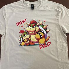 NOTE TO CUSTOMERS: Print design is high quality iron on through heat press. Cute shirt of Bowser and Bowser Jr. Comes in 3 variants, just the Bowser and Bowser Jr, father and son are best friends, or for the dad in your life. Shirts are available in tan and in sizes small, medium, large and extra large.  Shirt is Gildan brand unisex made out of cotton and polyester soft style for adults and heavy cotton for kids. Bowser Shirt, Mario Bowser, Bowser Jr, Dad And Son, Friends Shirt, Father And Son, Soft Style, Dad To Be Shirts, Cute Shirts