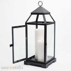 a black lantern with a candle inside on a white background