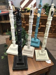 an assortment of decorative candlesticks sitting on top of a table