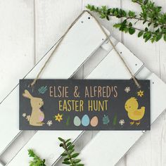 a sign that says elsie & alfredo's easter hunt hanging on a white wall