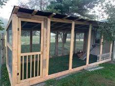 a small chicken coop in the grass