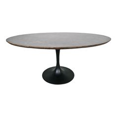 an oval table with a black base and white marble top, against a white background