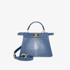 Iconic small Peekaboo ISeeU bag, the epitome of Fendi craftsmanship and creativity. A timeless icon, the Peekaboo was created in 2009. Like the children’s game it takes its name from, peek-a-boo, the bag plays with the beauty showcased on the outside and that concealed on the inside. Made of luxury, hand-polished blue stingray leather. Featuring a soft, blue nappa leather lining, two internal compartments separated by a stiff partition and an inner pocket. Gold-finish bar, closure and metalware. Fendi Peekaboo Iseeu, Fendi Bag, Fendi Peekaboo, Clutch Pouch, Women Essentials, Boot Accessories, Boston Bag, Peek A Boo, Fendi Bags