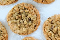 chocolate chip cookies sitting on top of white paper