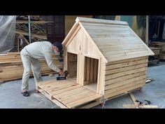 a man is building a dog house out of pallets