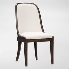 a white chair with wooden legs and a seat cushion on the back is upholstered