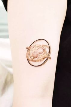 a woman's arm with a gold bracelet on it