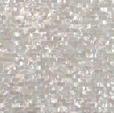 a white tile wall that is made out of mother of pearl