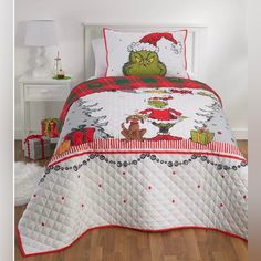 a bed with a christmas themed comforter and pillows