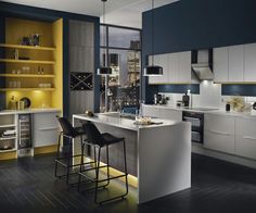 a modern kitchen with white and yellow accents