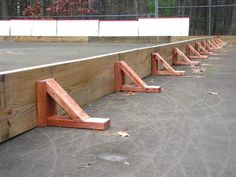 the tennis court is lined up with wooden railings on each side, and there are no people in it