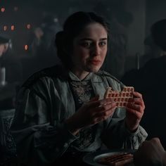 a woman sitting at a table eating waffles