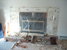 a living room with a fire place in the middle and debris everywhere on the floor