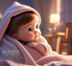 a baby doll wrapped in a blanket on top of a bed