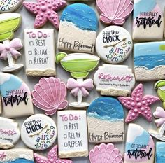 decorated cookies are arranged in the shape of seashells and beach themed words on them