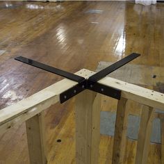 a wooden floor with some black metal straps on it