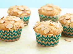 several muffins with oatmeal toppings are on a white surface