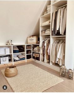 an attic closet with white shelving and shelves filled with clothes