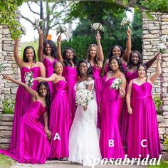 a group of women standing next to each other in purple dresses and holding bouquets