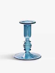 a blue glass vase sitting on top of a table