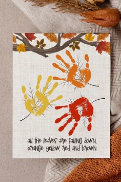 a card with an image of two hands and the words, all the leaves are falling down orange yellow red and brown