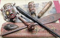 several different types of masks and knives on display