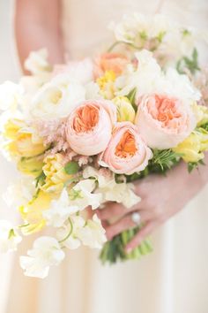 a woman holding a bouquet of flowers in her hands