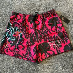 Pocket Mesh Graphic Drawstring Summer Short Length Swim Trunks For Streetwear, Black Bottoms For Streetwear And Beach Season, Short Bottoms For Streetwear Beach Season, Pink Short Swim Trunks For Spring, Casual Pink Short Length Swim Trunks, Pink Short Length Swim Trunks For Spring, Short Swim Trunks For Streetwear In Spring, Pink Relaxed Fit Bottoms For Beach Season, Ed Hardy Shorts Outfit