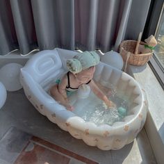 a small child in an inflatable bath tub