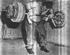 a man is lifting a barbell in an old black and white photo with the caption