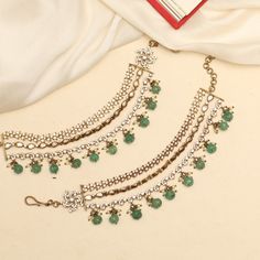 Description: Embrace luxury sophistication with the Aparaa Victorian Polish ear chain, adorned with brilliant moissanite stones, CZ stones, emerald green pumpkin beads, and cluster pearls. This floral masterpiece is perfect for bridal parties or festivals, adding a touch of royal charm and sparkle to your look. Elevate your style with this exquisite accessory! Product Information: Metal: 925 Silver with Victorian Plating Length: 13cm Stones: High Grade CZ Stones Elegant Green Bridal Earrings For Reception, Bollywood Green Bridal Earrings For Reception, Elegant Green Kundan Bridal Earrings, Elegant Bridal Necklace With Latkans For Party, Elegant Party Bridal Necklace With Latkans, Green Pearl Chain Jewelry For Wedding, Elegant Green Bridal Earrings With Tilla, Traditional Emerald Bridal Necklace For Party, Traditional Emerald Bridal Necklace For Wedding